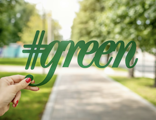 Woman Holding #green Up Against a Park Background